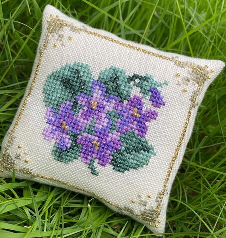Violets pincushion by @tamara_cross_stitch